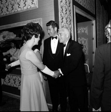 Chancellor William J. McGill shaking hands with a lady in the receiving line at the UC San Diego Faculty Ball