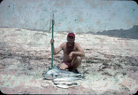 James Ronald Stewart posing with some fish he caught while spearfishing