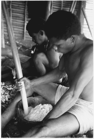 Men pounding taro and coconut pudding.