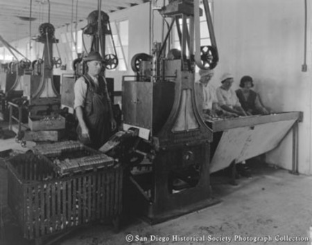 Man and three women canning sardines at Neptune Sea Food Company cannery