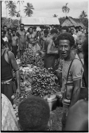 Mortuary ceremony: men with piles of yams, taro, and betel nut for initial payment to mourners