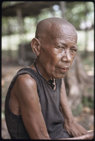 Bomtavau, an older woman, with newly shaven head, a sign of mourning