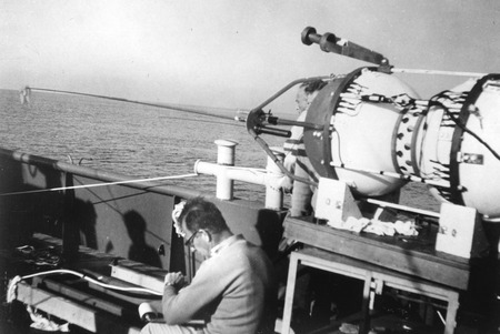Walter Munk working topside during a scientific expedition