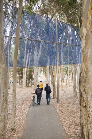 Two Running Violet V Forms: detail showing students walking under a section of fence