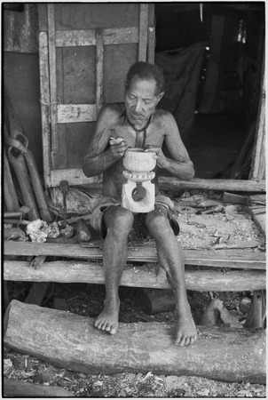 Carving: M&#39;lapokala makes a wooden bowl with stand, probably for tourist trade