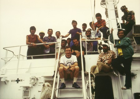 Aboard the Toyoshire Maru off the coast of Japan: David Checkley (front, stairs); Michael Mullin (dark shirt, behind Check...