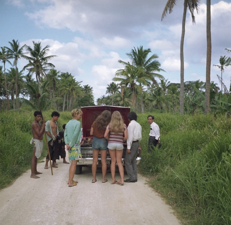Young Tongans curious, Valerie Craig and Yoshio Horibe at car