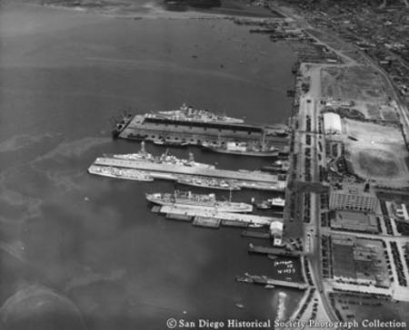 Aerial view of ships docked at B Street, Broadway, and Navy piers, San Diego harbor