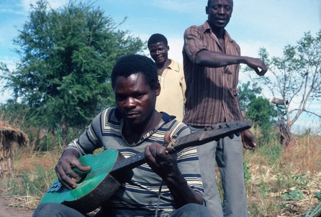 Bisa guitarist and dancing men at Nabwalya