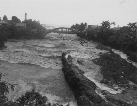 Tsunami tidal wave surging up an inlet channel, near Hilo on the Big Island of Hawaii