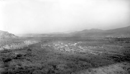 The El Rosario Valley, facing east, from near the big bend on north side with pueblo on the right side