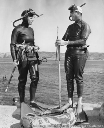 Divers Glenda McLean and Chuck Boswell in wet suits with spear guns