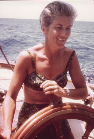 Marge Bradner at the helm of the Schooner DWYN WEN, wife to Scripps Institution of Oceanography Dr. Hugh Bradner. She help...