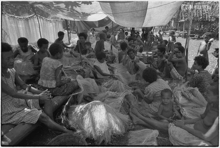 Mortuary ceremony: women gathered to weave long fiber skirts for ritual exchange