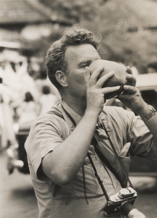 Robert S. Diezt drinking from a coconut, Ceylon