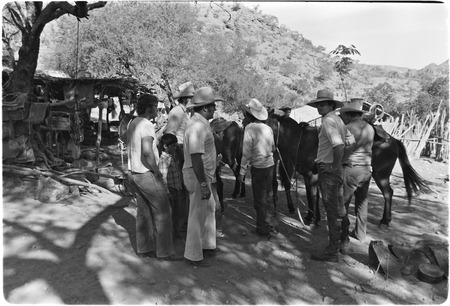 Ranchers inspecting saddle at Rancho San Martín