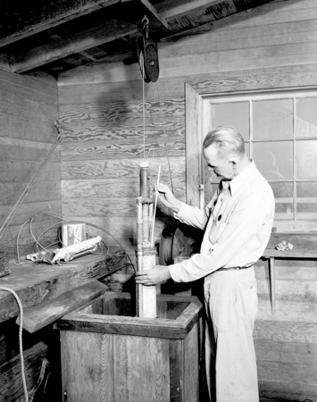 Claude W. Palmer using water sampler on Scripps Institution of Oceanography pier