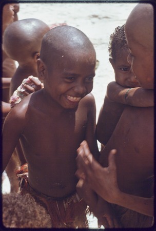 Children on the beach at Kaibola (close-up), heads shaved as a sign of mourning