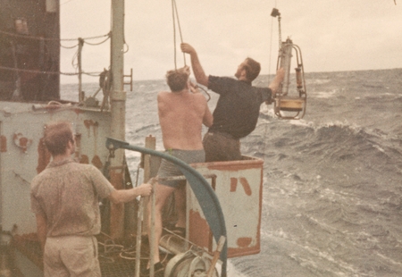 George Hohnhaus (left) and Baron E. Thomas (right) lowering pinger on R/V Horizon during Nova Expedition, July 1967
