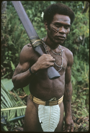 Man with fo&#39;osae plaited cane belt and carrying a morimori club.