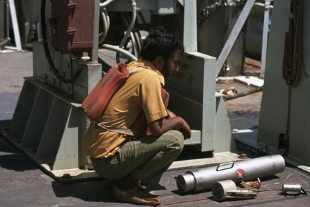 [Man on deck with scientific instrument], GEOSECS Indian Ocean
