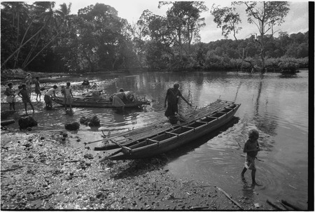 Canoes: women load baskets and pots onto small canoes used for coastal transport