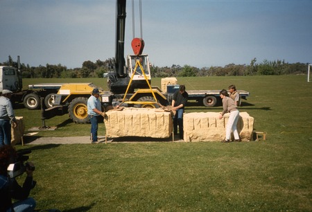 UNDA: view of installation process: crane lowering stone block into place