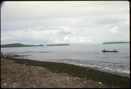 People in a canoe, with island in the background