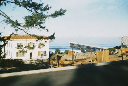 Construction material near Ritter Hall for the Ritter Hall addition, with the Scripps Pier in the background. 1955.