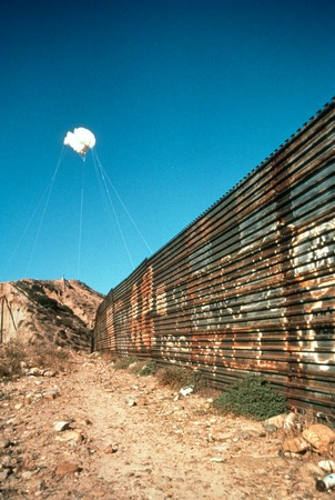 The Cloud: white balloons suspended in the sky over the United States/Mexico border wall