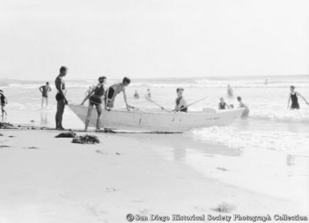 Lifeguards pushing lifeboat into surf at Ocean Beach