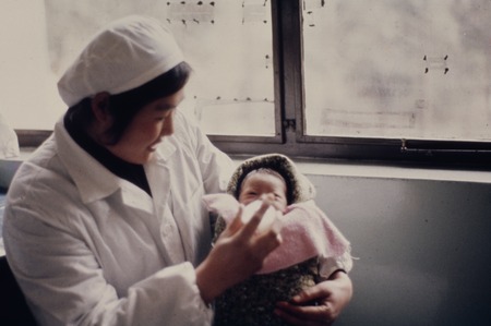 Luda Shi No. 2 People&#39;s Hospital, medical worker taking care of infant