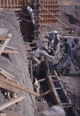 Construction workers pouring concrete into footing during construction of a new building on the campus of Scripps Institut...