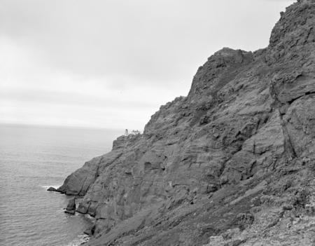 Lighthouse from lee cliffs, Point Reyes, Marin Co., California. One view shows sea lion beach, circa 1954