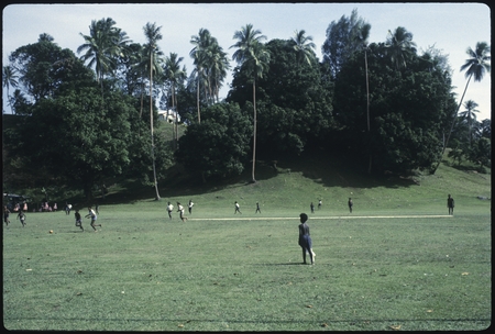 Boys playing football in a field