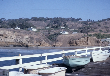 Looking northeast from the original Scripps wooden pier to the campus of Scripps Institution of Oceanography, some cottage...