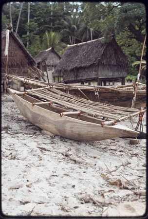 Canoes on the beach at Wawela village, houses in background