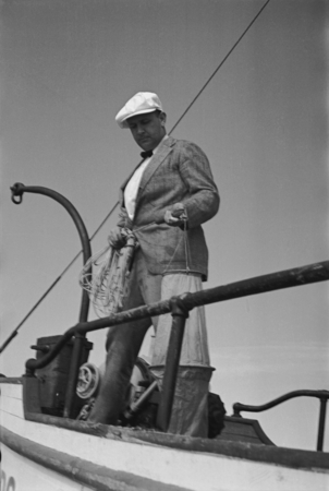Denis Llewellyn Fox holding a plankton net to collect marine specimens on R/V E.W. Scripps