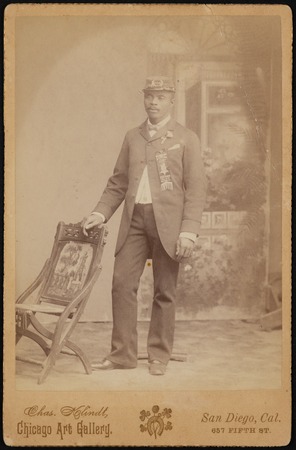 Studio portrait of an African American man with Grand Army of the Republic hat and badges