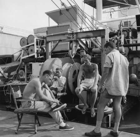 Arthur Maxwell and group on ship fantail