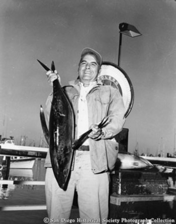 Sportfisherman posing with catch at weigh station