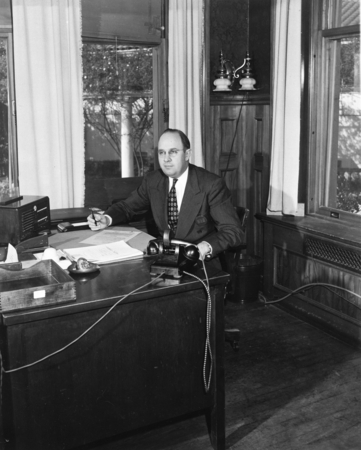 Man at desk in Building X, Point Loma, University of California Division of War Research