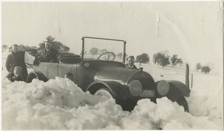Automobile surrounded by snow banks in Cuyamaca