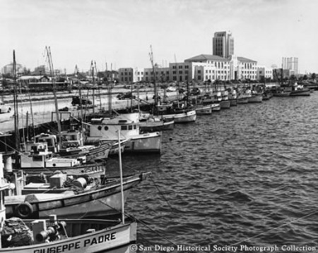 Fishing boats docked along Embarcadero near San Diego City and County Administration Building