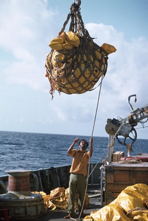 [Man lifting equipment on deck], GEOSECS Indian Ocean