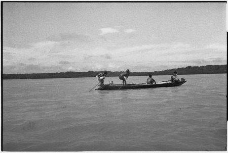 Canoes: men on a small outrigger canoe, pot on platform (l)