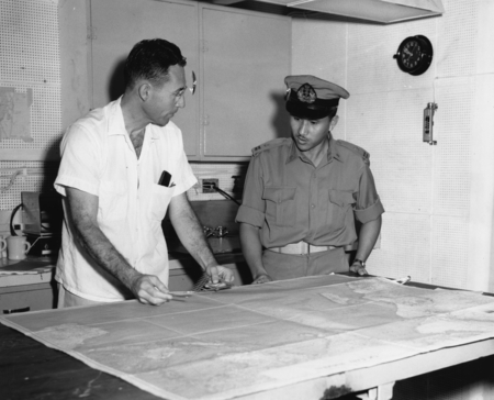 At an open house aboard the ship Argo, Robert Lloyd Fisher shows Capt. Lumanaw, Officer of the Indonesian Naval Hydrograph...