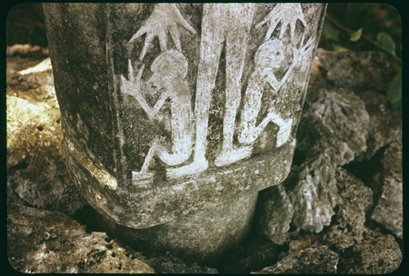 Closeup of a dolo or burial urn chisled from a single block of limestone and set upon a pyramid of coral slab