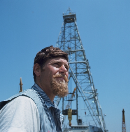 Unidentified Deep Sea Drilling Project staff member on the deck of the research ship D/V Glomar Challenger. Circa 1968.