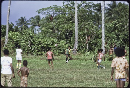 Soccer (football) players in action, ball in the air